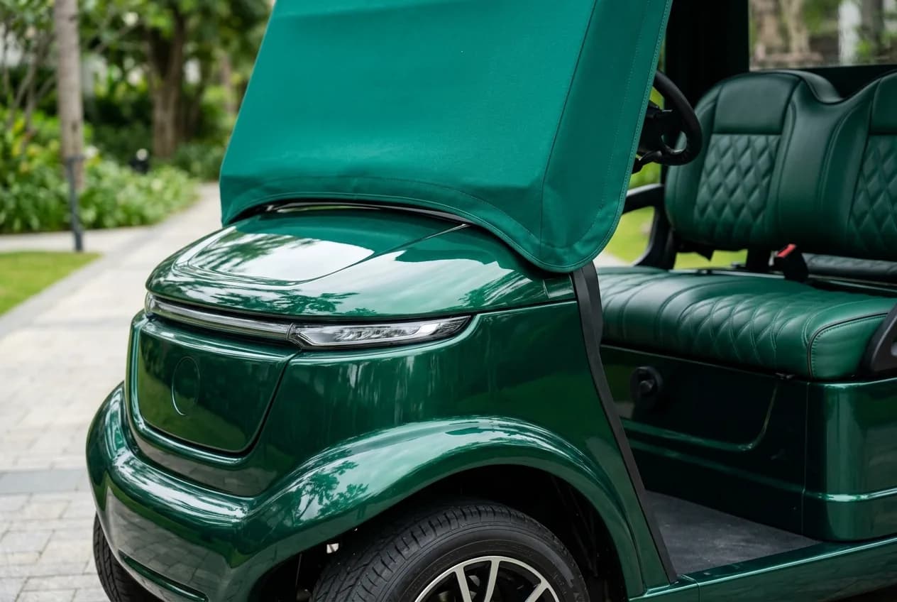 Close-up of a custom-colored electric cart panel with a clean logo and matched trim