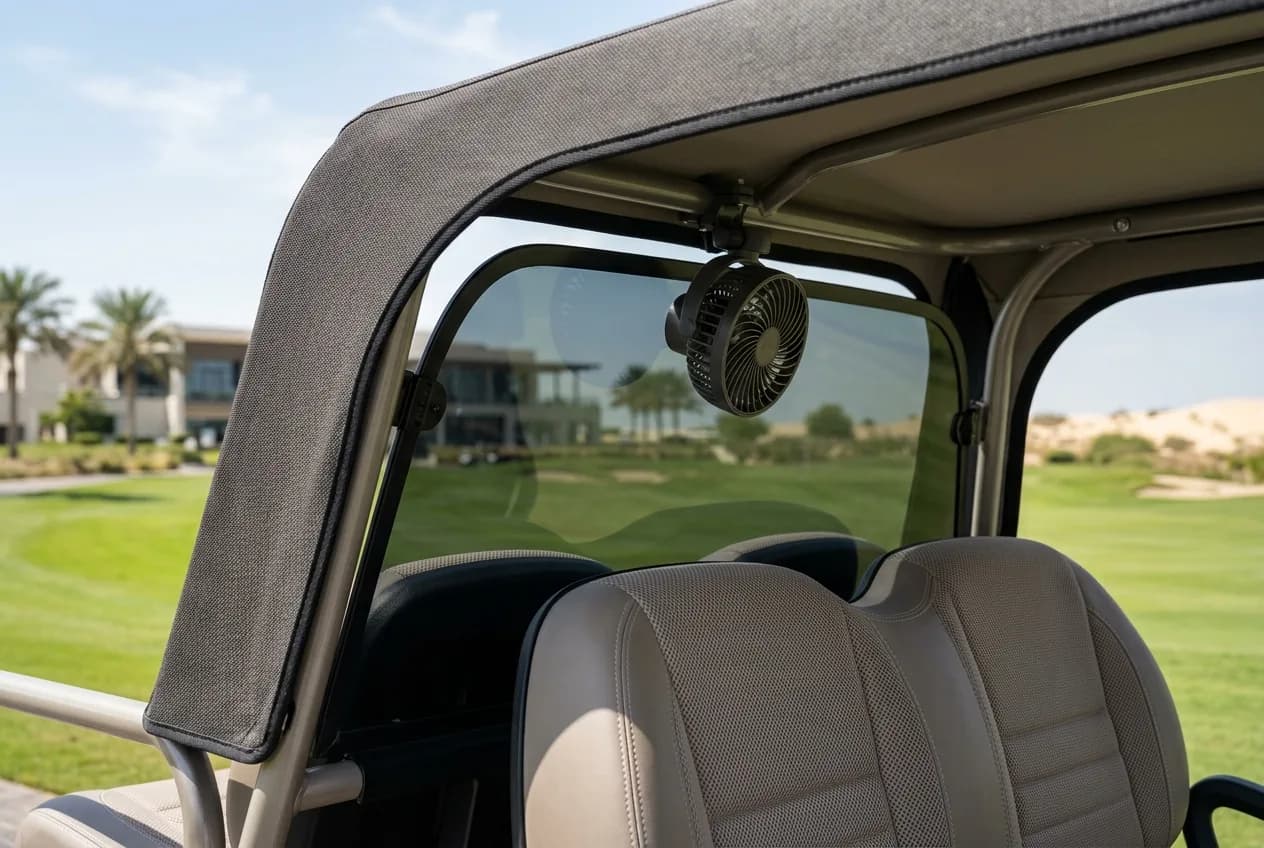An electric golf buggy with a light canopy roof and tinted screen parked under bright Gulf sun beside palms